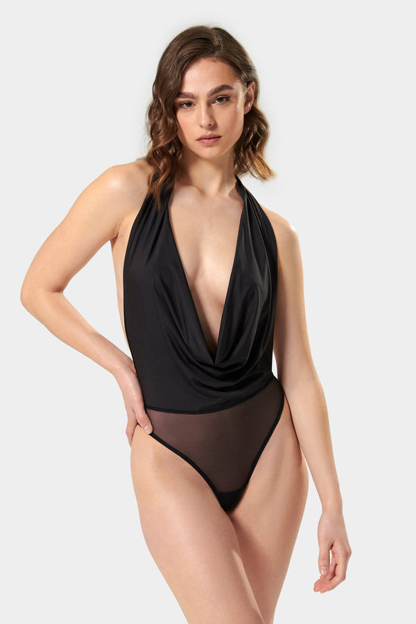 Take your underwear-as-outerwear game to another level with the sleek Ocean bodysuit by Bluebella. Minimal yet memorable, this fashion-forward piece features a plunging cowl neckline that brings a soft touch to your silhouette and can be adjusted with halterneck ties. Explore its styling potential by wearing it with your favourite high-rise pieces, or enjoy its flattering shape by slipping it on solo.