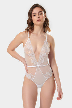 Bridal boudoir, anyone? Elegance and art meet in the soft and chic Rafaela bodysuit. Lingerie lovers won’t be able to resist the impact of the unique, swirling embroidery and the delicate, semi-sheer mesh creating a perfectly provocative finish. Complete with gold-tone hardware and sleek criss-cross straps to the reverse, the white Rafaela is a romantic option that guarantees to set pulses racing.