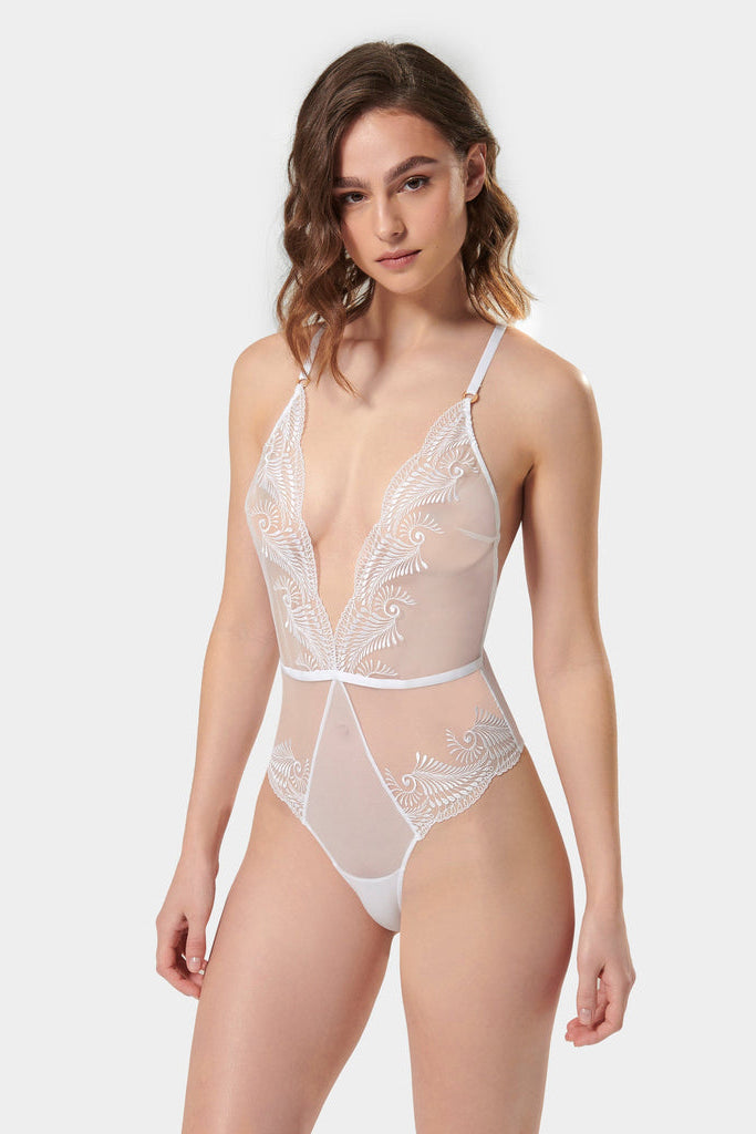 Bridal boudoir, anyone? Elegance and art meet in the soft and chic Rafaela bodysuit. Lingerie lovers won’t be able to resist the impact of the unique, swirling embroidery and the delicate, semi-sheer mesh creating a perfectly provocative finish. Complete with gold-tone hardware and sleek criss-cross straps to the reverse, the white Rafaela is a romantic option that guarantees to set pulses racing.
