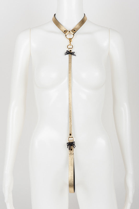 Command attention with the Oro Lead by Fraulein Kink featuring detachable metallic gold leather lead, 18K gold trims and Swarovski® jet black crystal rivets. Wear the collar with your favorite outfit and attach the lead for an adventurous erotic moment.  Metallic Gold Leather Upper Shiny Black Patent Leather Lined SWAROVSKI® Jet Black Crystal Rivets Detachable Gold Leather Lead Fräulein Kink Logo Embossed Handmade to Order in Berlin